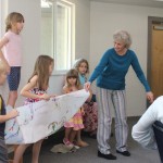 Firstday students showing the card they made for Sybil after her knee replacment.