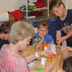 Firstday class: Laura teaching how to make a noisemaker.